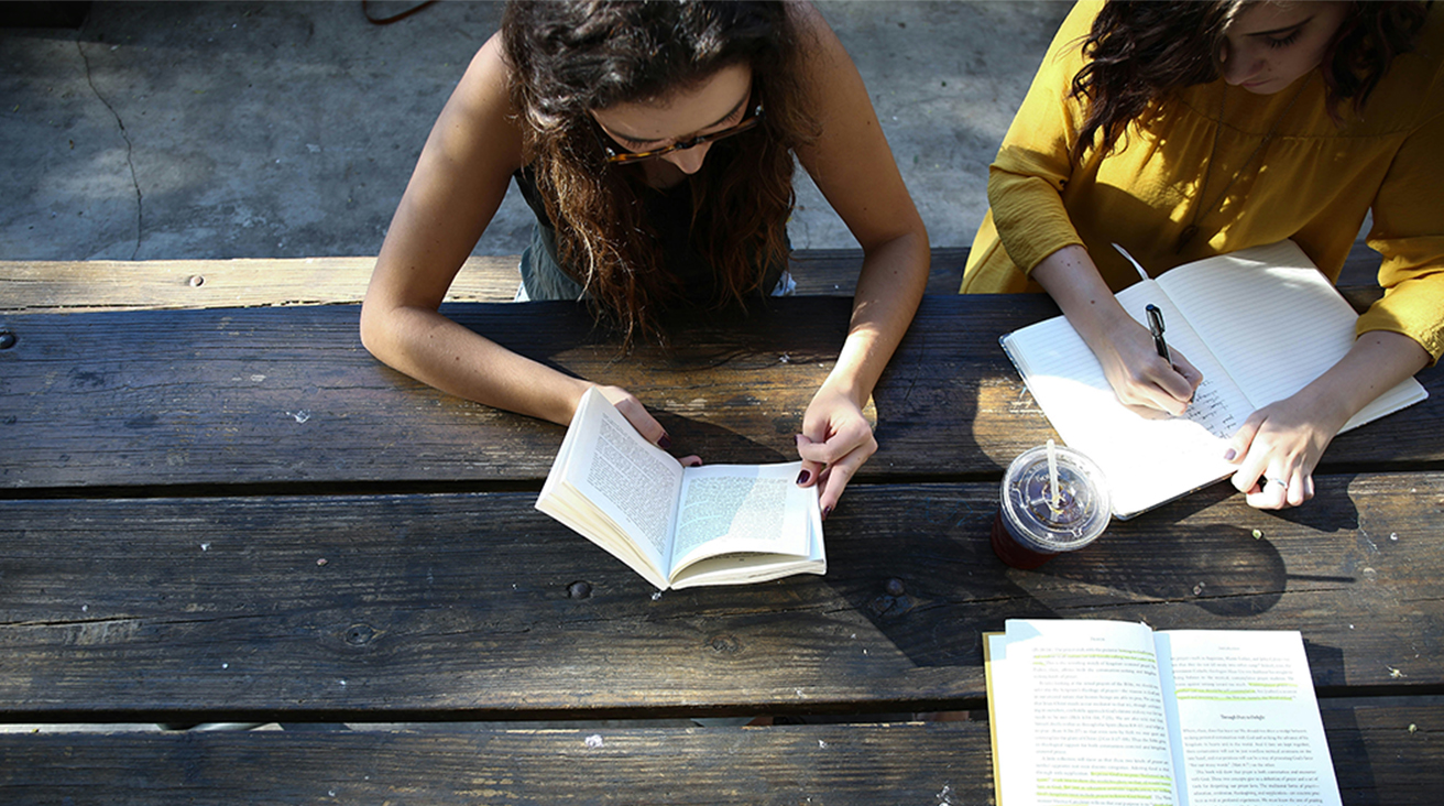 People reading at table