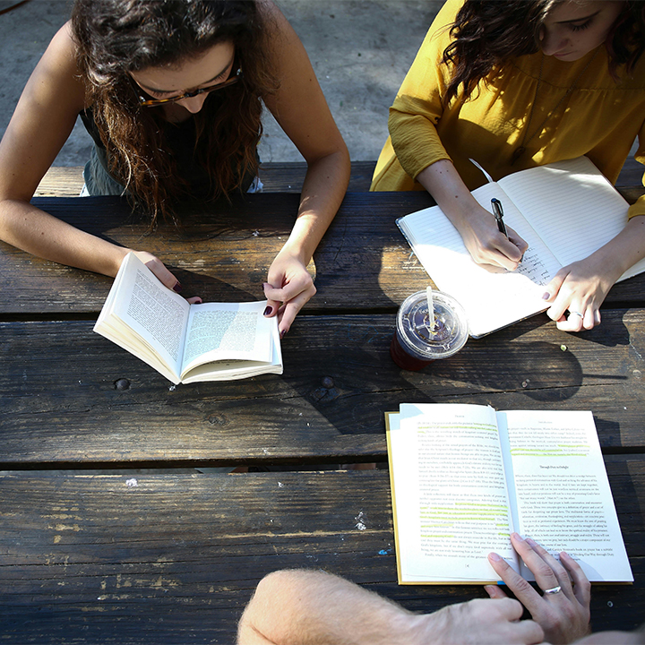 People reading at table