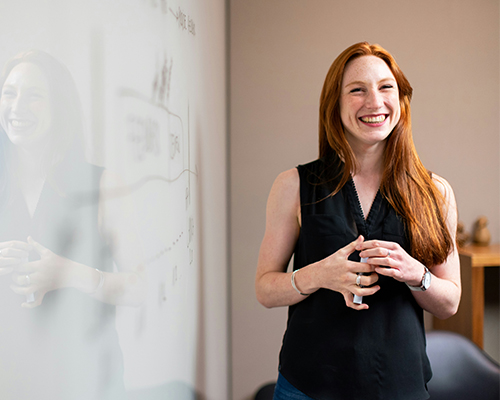 Woman beside whiteboard