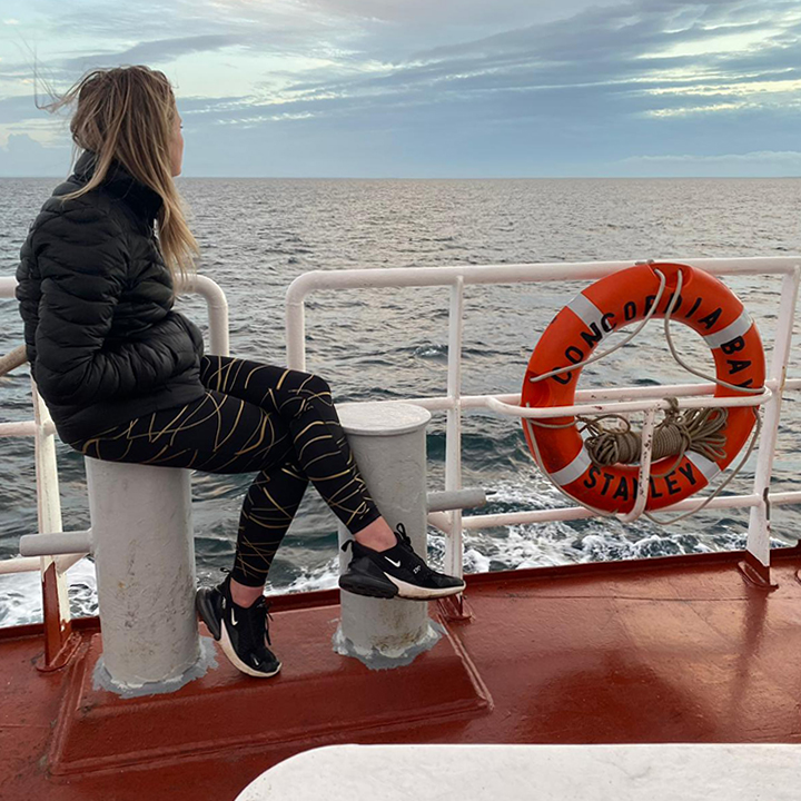 woman looking out to see from boat