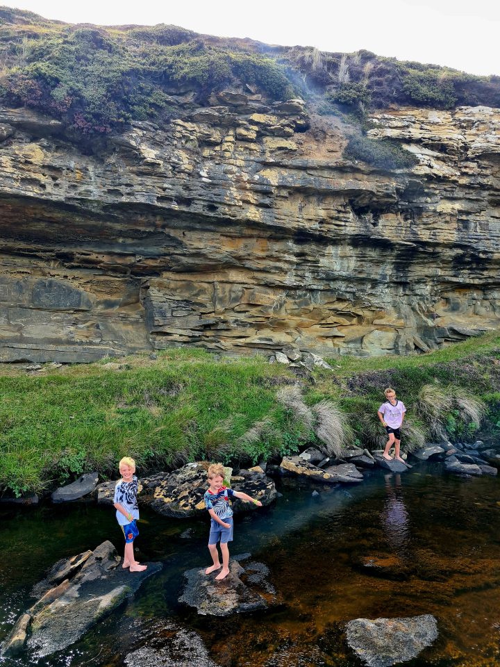 kids playing in a river in the Falklands